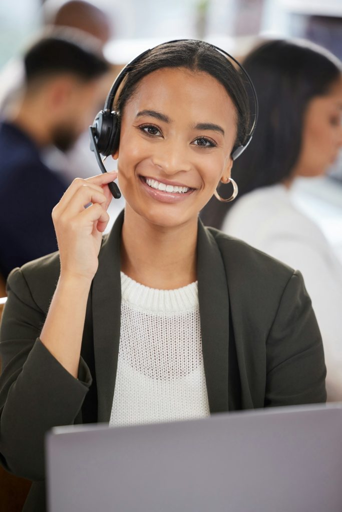 Portrait of a young businesswoman working on a laptop in a call centre